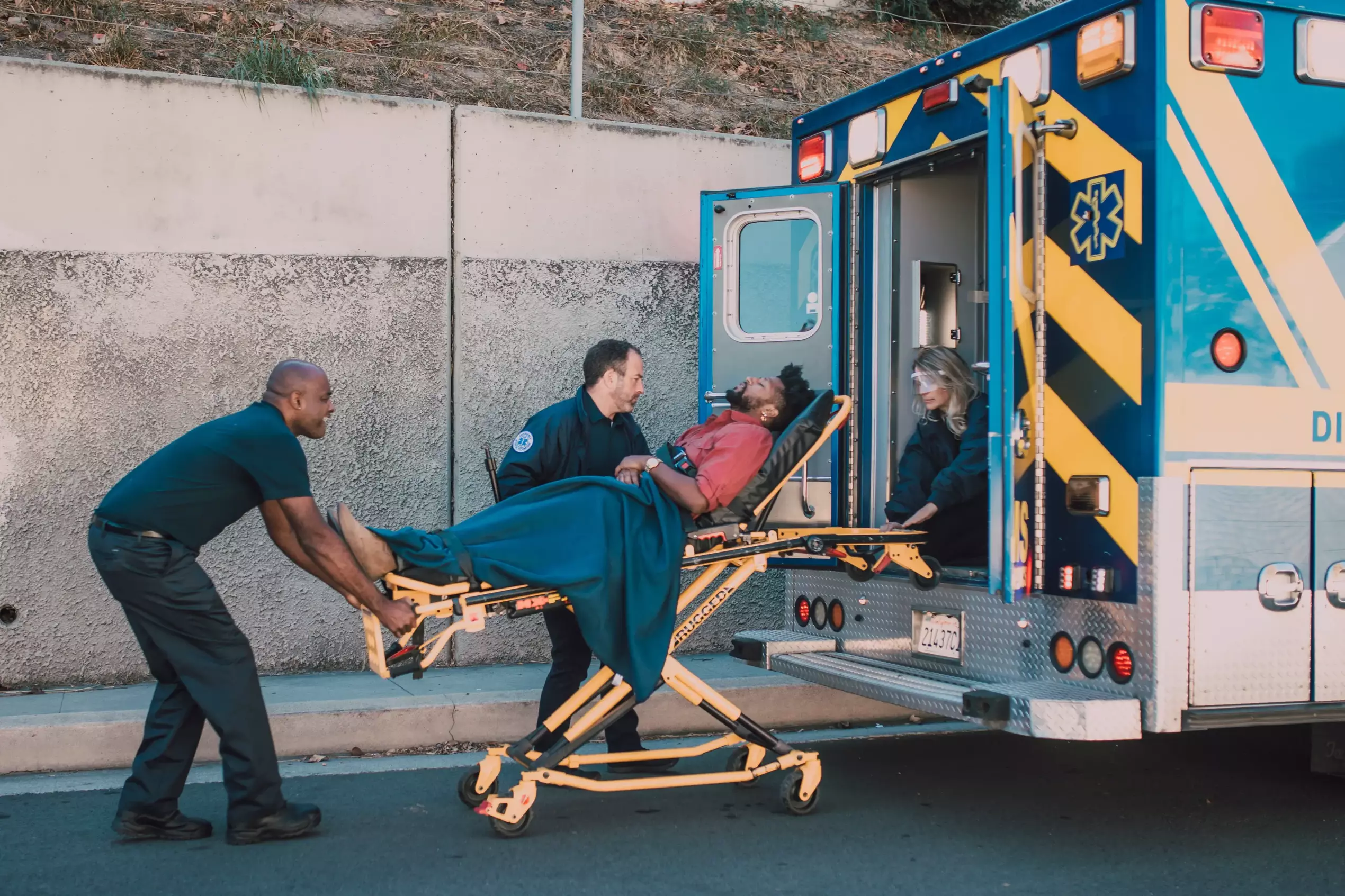 Man being loaded into an ambulance.