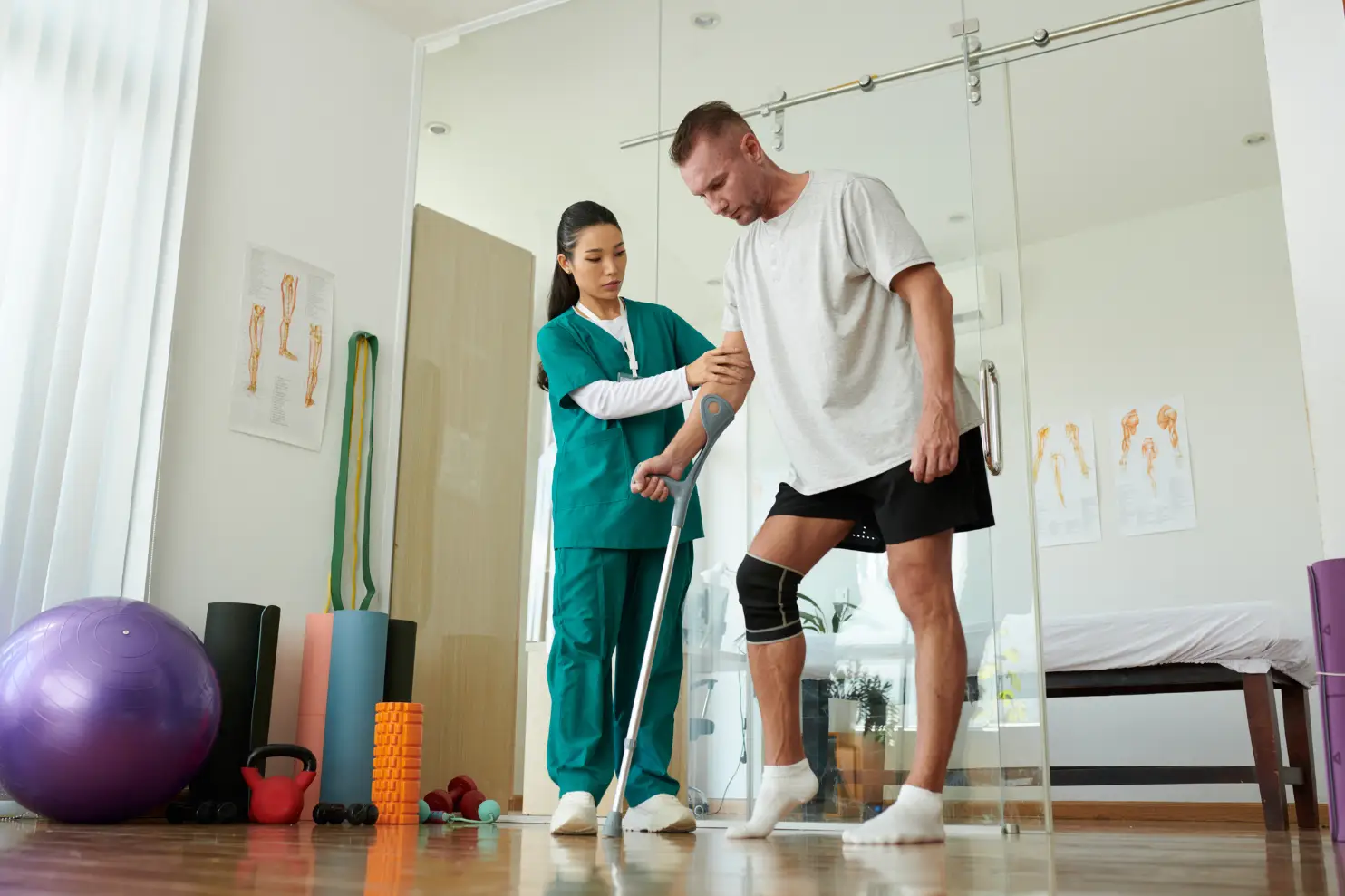 A physical therapist working with an injured man.