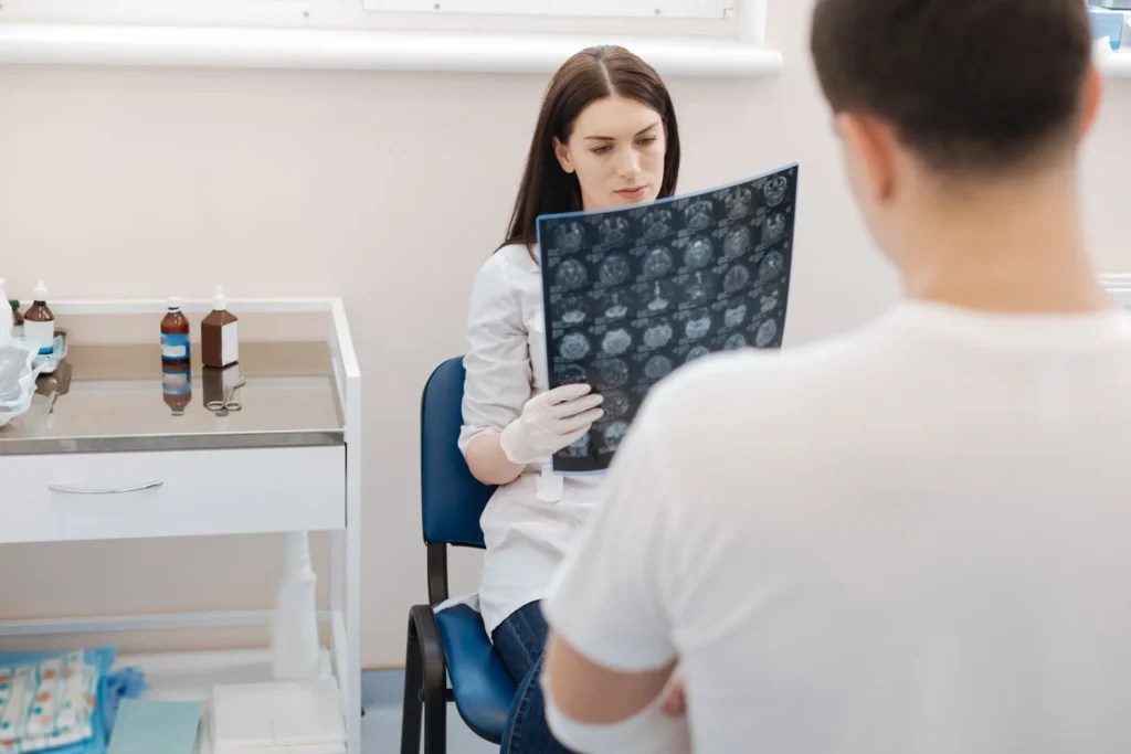 A doctor assistant looking over MRI scans.